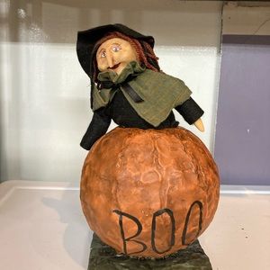 Vintage Halloween witch in pumpkin.